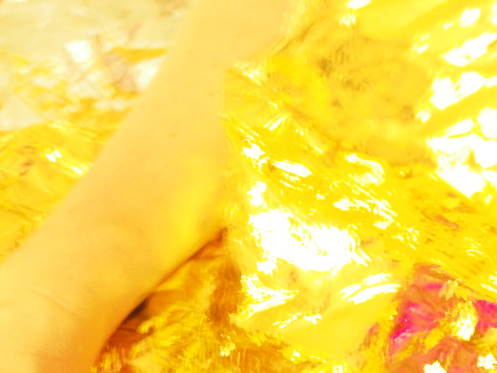 Human skin in contact with a golden thermal blanket; the rescue material on the body.